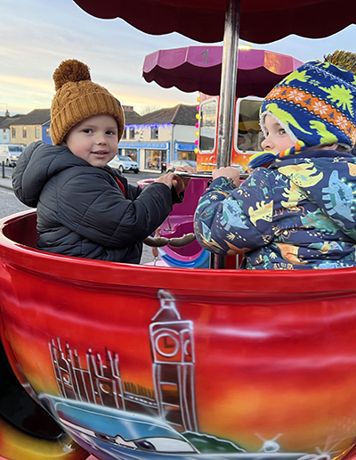 Children enjoying a festive fairground ride